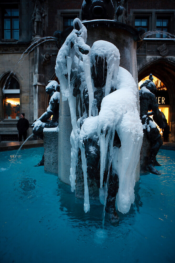 Frozen fountain in Mary's Square in the evening, Munich, Bavaria, Germany