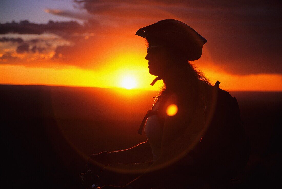 Tracey Weber mountain biking The Deadline Ridge Trail at sunset which is located high in The Goose Creek Mountains Idaho USA