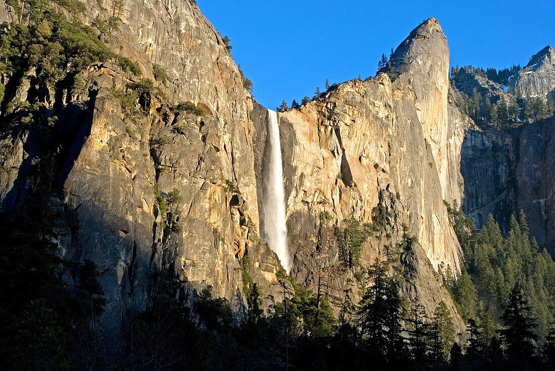 Bridalveil Falls and Leaning Tower at sunset in Yosemite Valley at Yosemite National Park in California USA