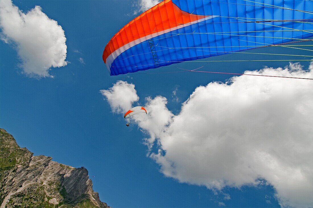 Elijah Weber landing after paragliding at Le Brevent in the Aiguilles Rouges high above the city of Chamonix France