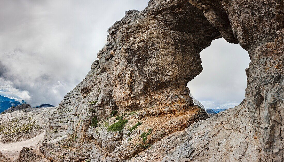 Panorama of the rock window in Mt Kanin near Bovec in the Julian Alps The saying goes, that the devil was fleeing and tried to jump over Mt Kanin he failed and smashed into the rock face of Mt Kanin creating this window Europe, Central Europe, Slove