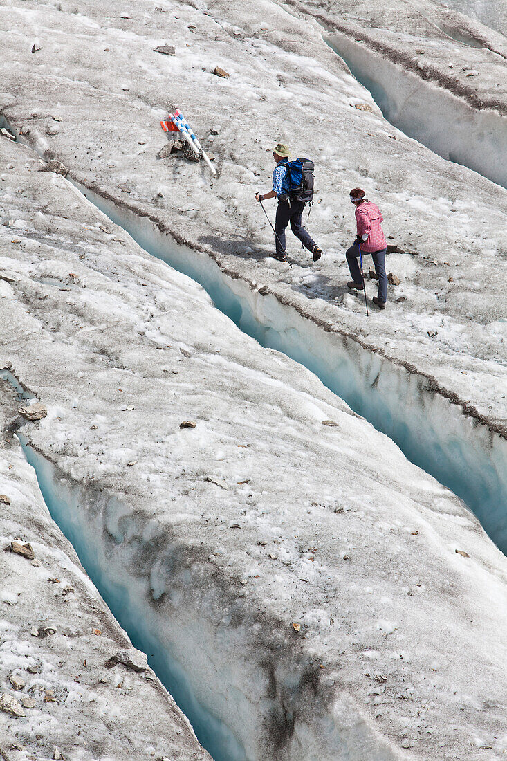 Two hikers on Gorner glacier to Monte Rosa Hut, Zermatt, Canton of Valais, Switzerland, myclimate audio trail