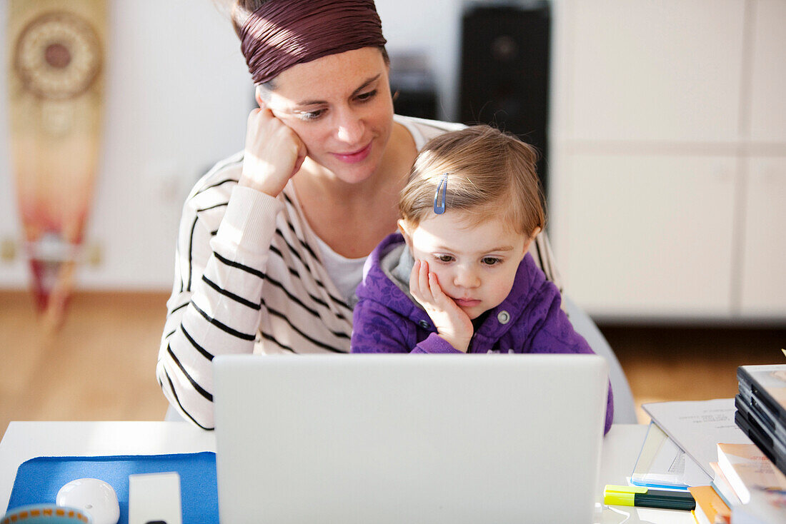 Woman and daughter (2 years) using a laptop, Vienna, Austria