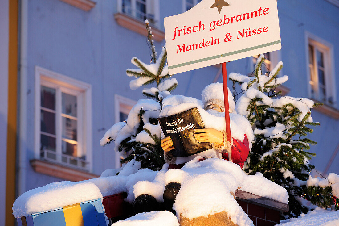 Snow covered Santa Claus reading in recipe book, Christmas market Rosenheim, Rosenheim, Upper Bavaria, Bavaria, Germany, Europe
