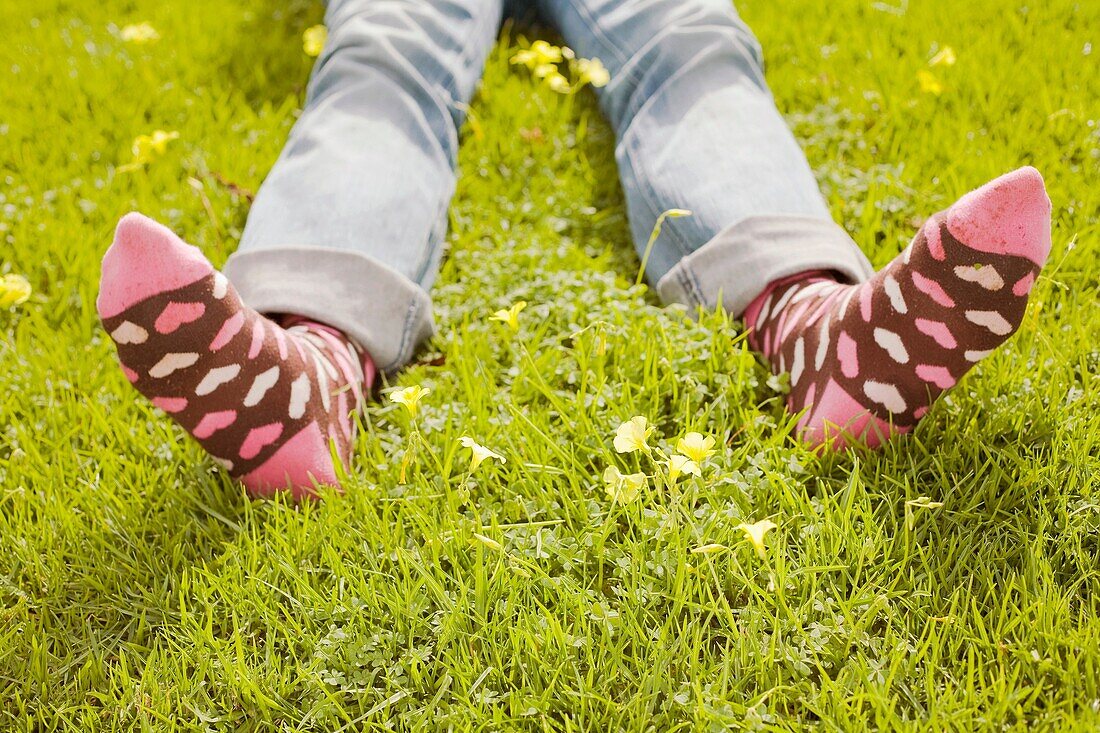 Woman on a green lawn with decorative socks