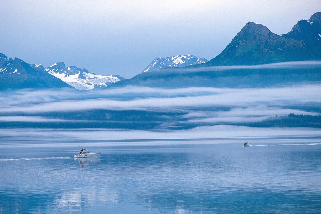 Mist surrounding Chugach mountains, boats on Prince William sound near Valdez, Alaska