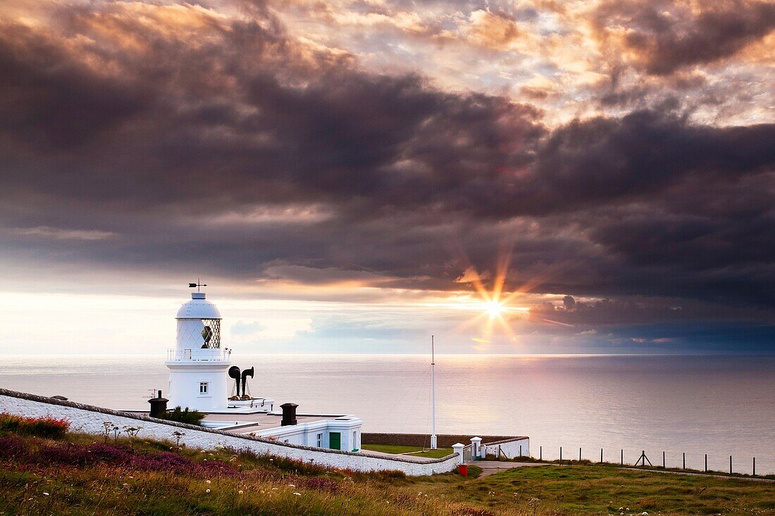 Dramatic sunset at Pendeen Lighthouse Cornwall England UK