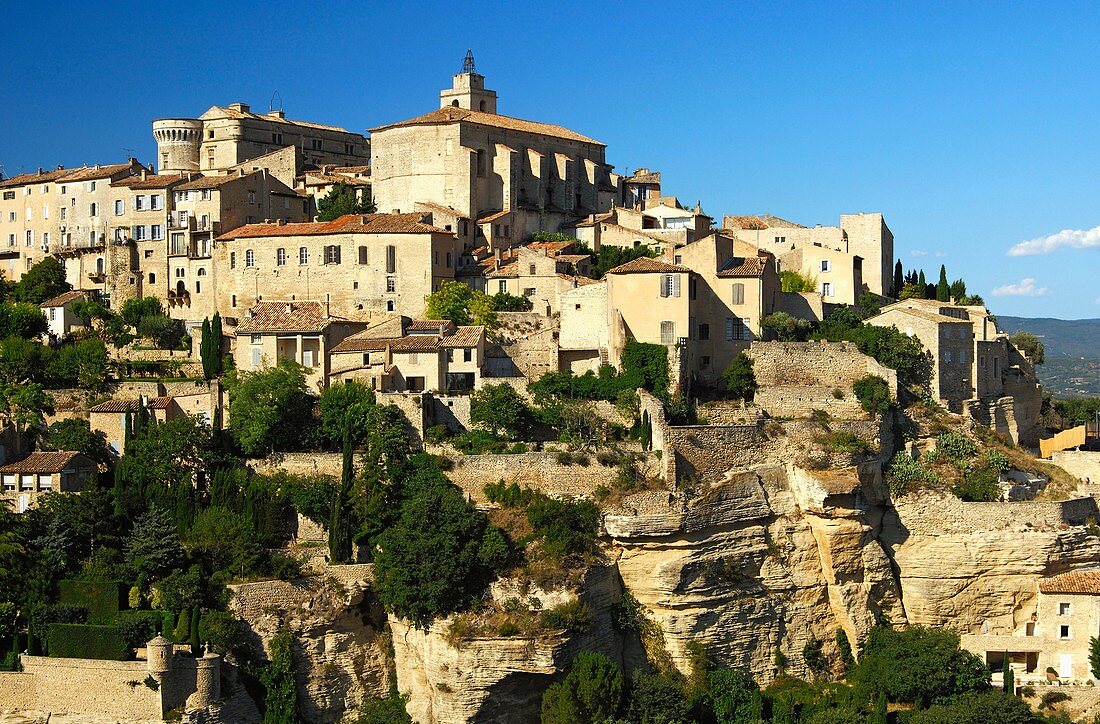 Gordes with the Château de Gordes and the Saint-Firmin church on the Monts de Vaucluse hill, Provence, France