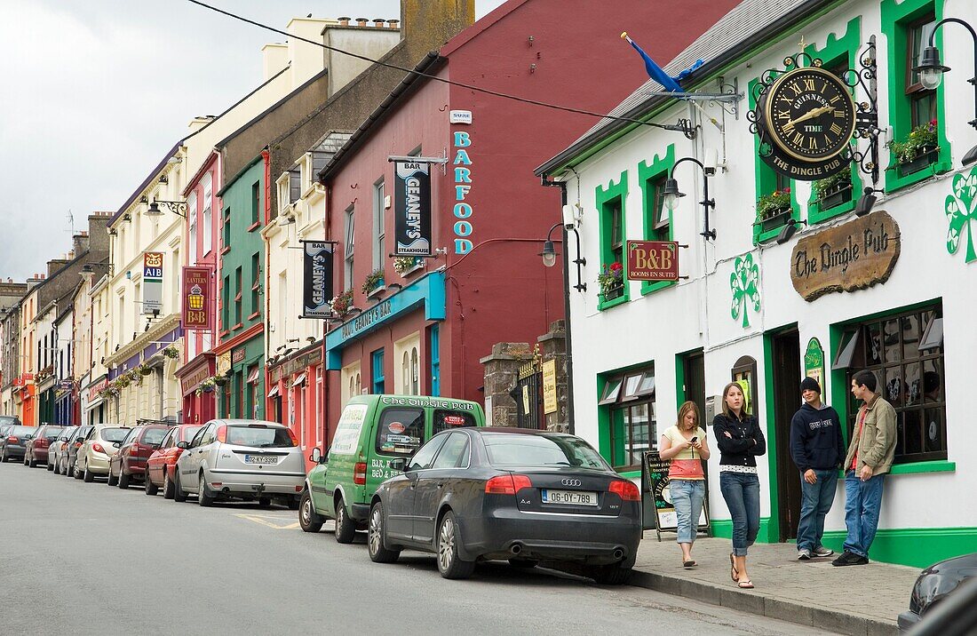 Dingle, west Kerry, famous for its pubs, music and relaxed atmosphere Young men and women on the main street