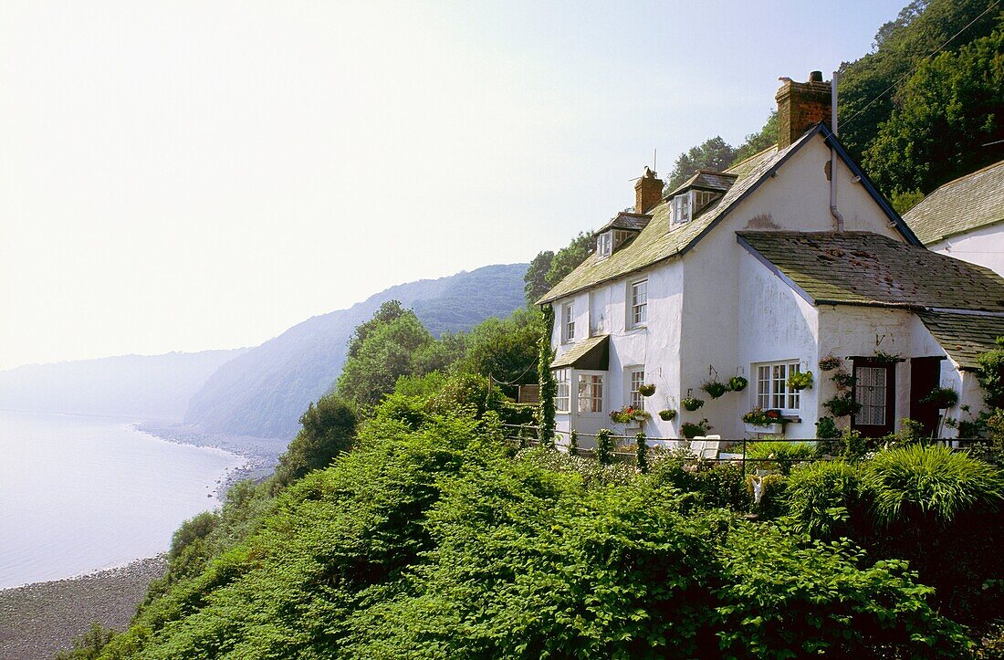 House on cliff at fishing harbour of Clovelly on north coast of Devon, England On Long distance South West Coast Path