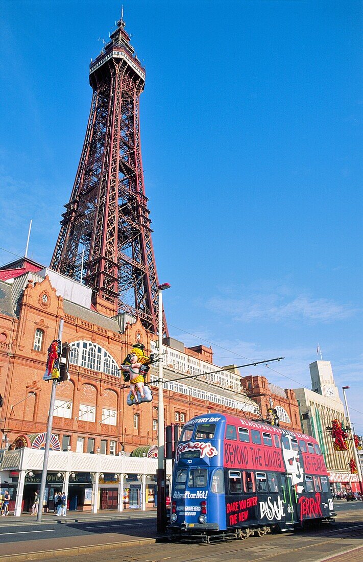 Blackpool Tower and traditional historic electric tram on the sea front at the seaside resort of Blackpool, Lancashire, England