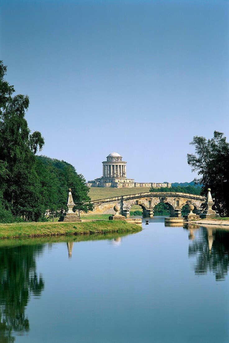 Mausoleum designed by Nicholas Hawksmoor beyond the New River Bridge Gardens of Castle Howard stately home, Yorkshire, England