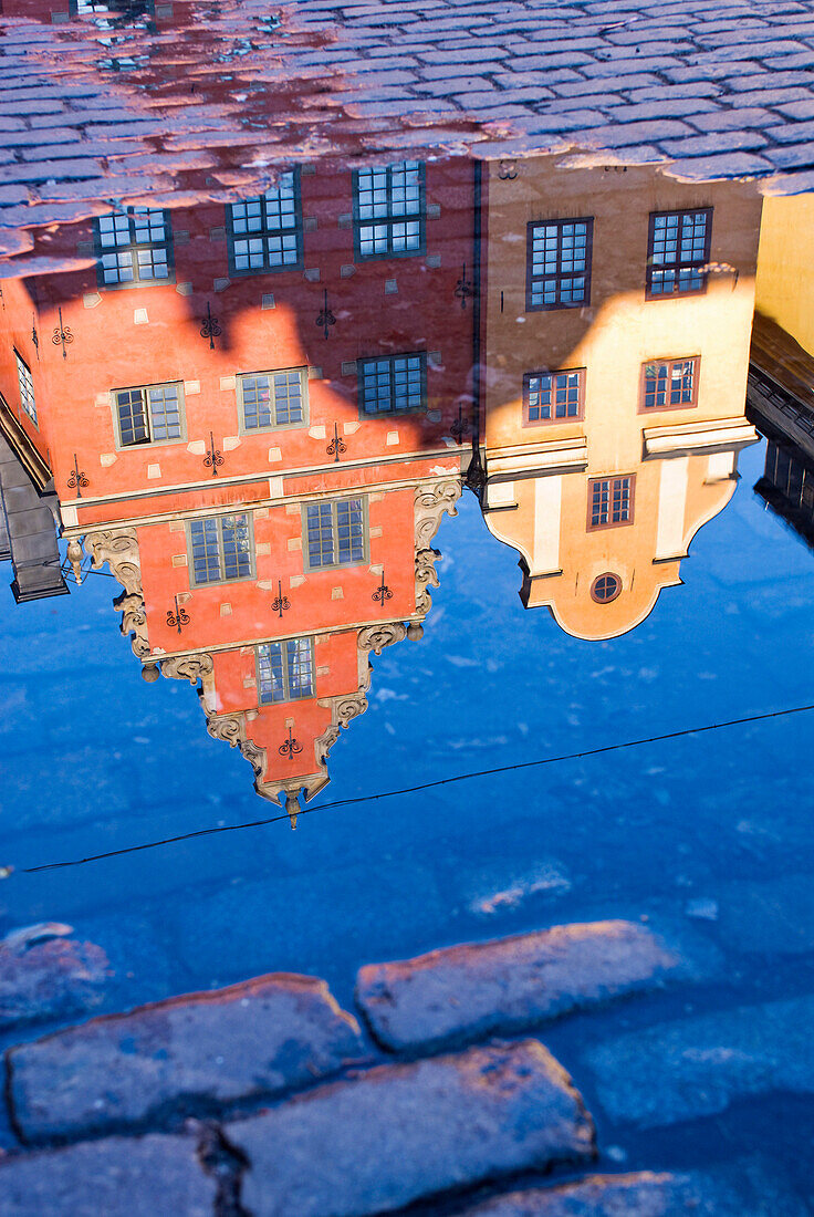 Buildings reflected in puddle, Stockholm, Sweden