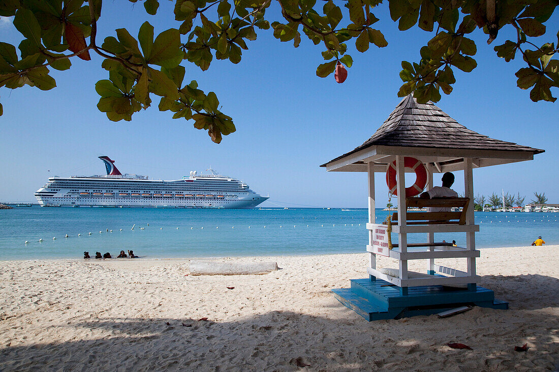 Beach with lifeguard tower and cruise ship, Ocho Rios, Jamaica, Caribbean