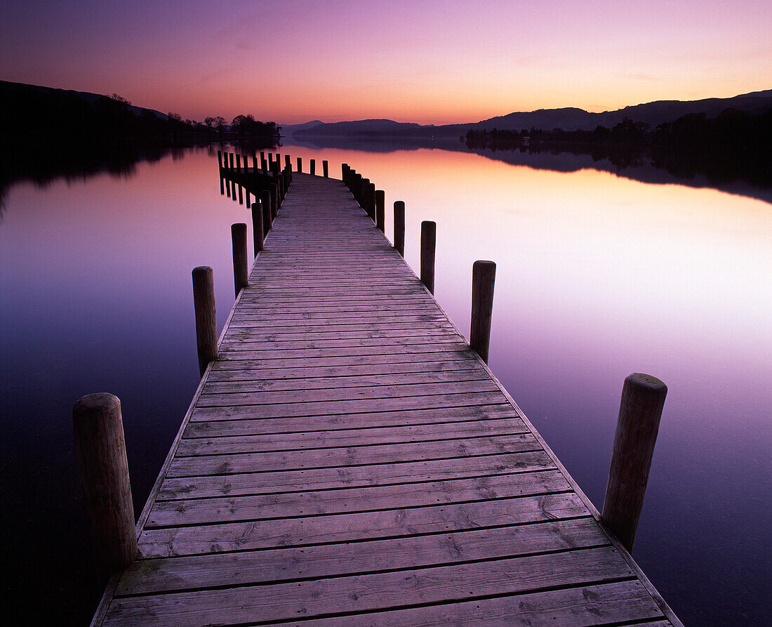 Sunset on Coniston Water from Waterhead jetty, Coniston, Cumbria, UK - England