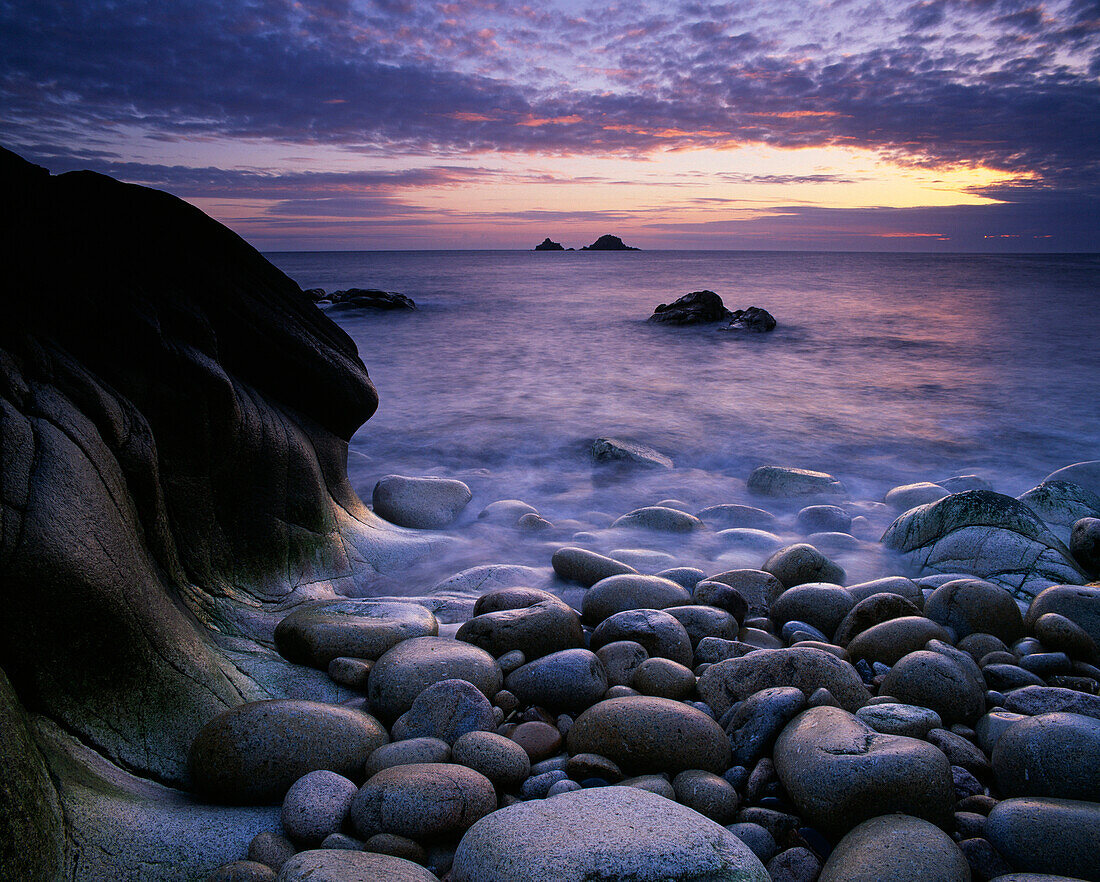 Beach and view to The Brisons rocks at sunset, Porth Nanven, Cornwall, UK - England