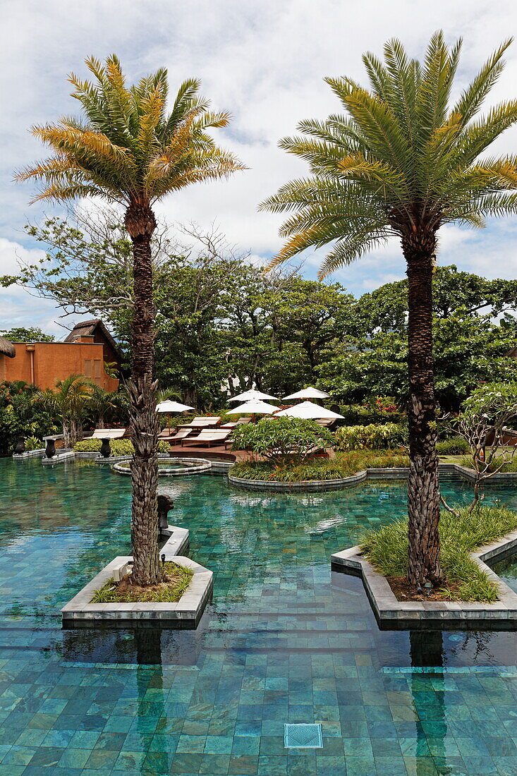 Pool of the Shanti Maurice Resort under clouded sky, Souillac, Mauritius, Africa