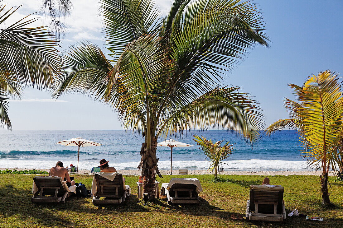 People and palm trees on the beach at Hotel Saint Alexis, Saint Gilles les Bains, La Reunion, Indian Ocean