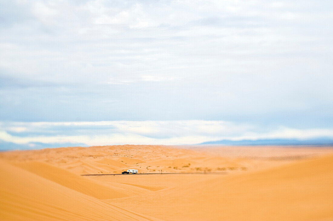 Truck Driving Through Desert, Imperial Sand Dunes, California, USA
