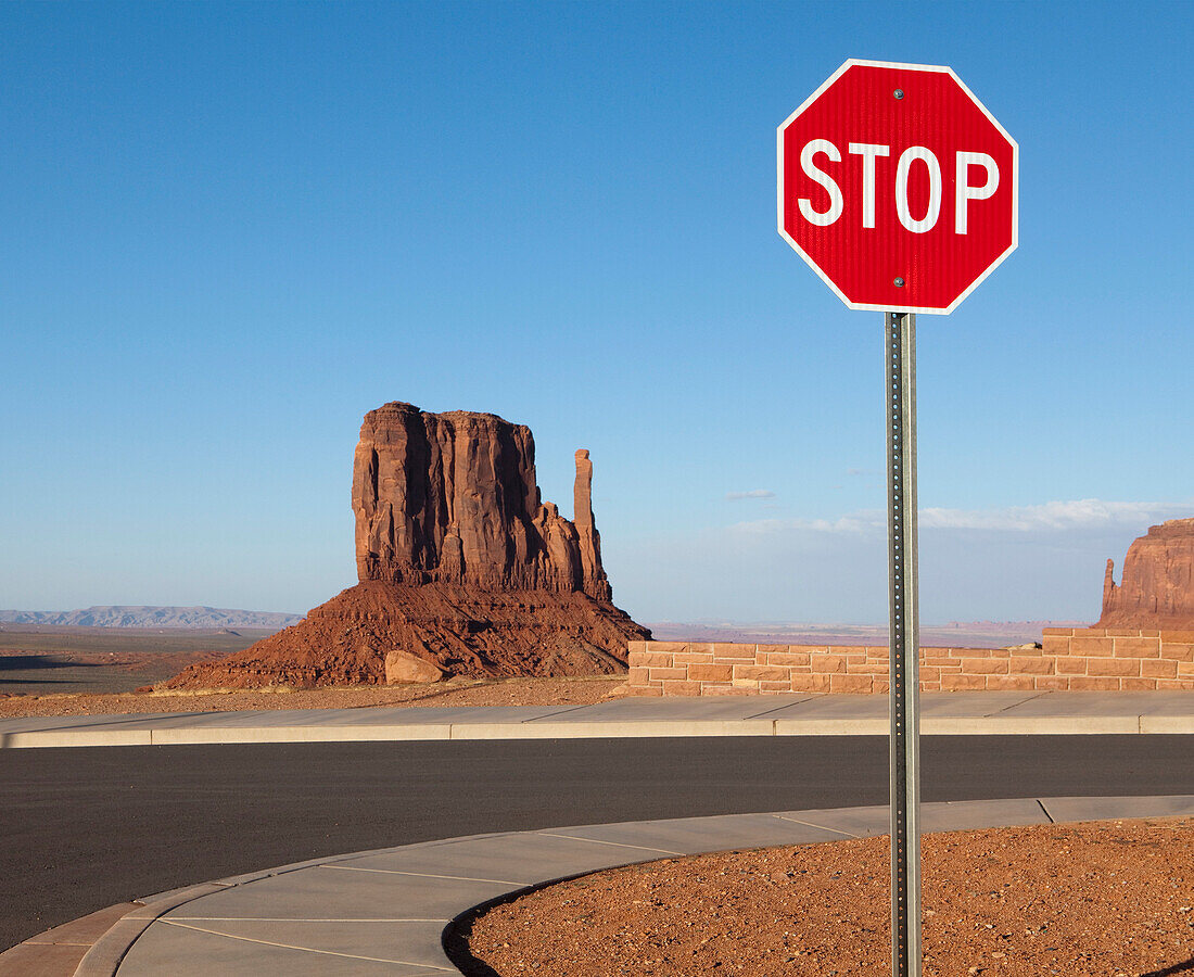 Stop Sign and Mesa in the Desert, Monument Valley, AZ, USA