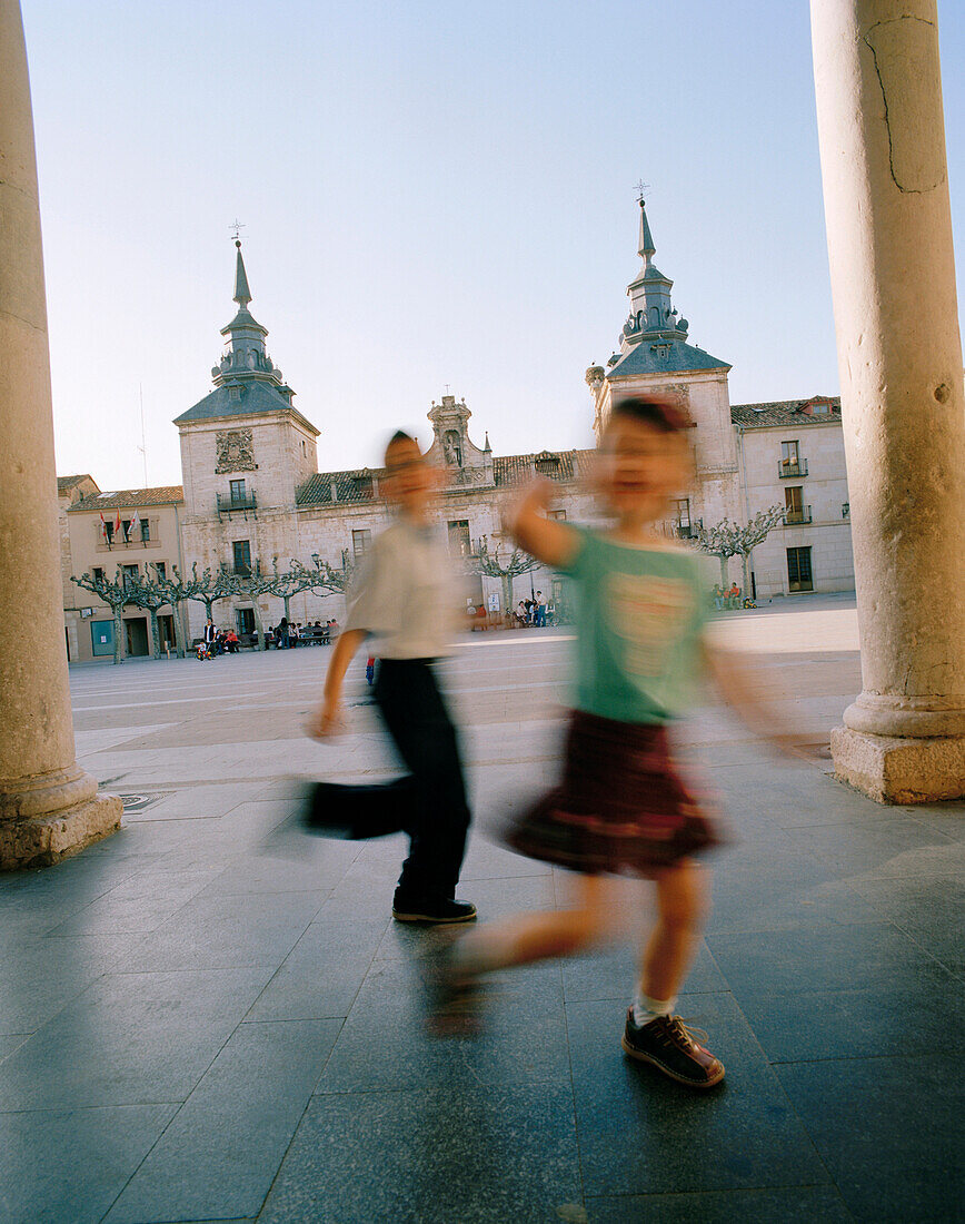 Kids playing on the town square, Plaza Mayor, El Burgo de Osma, Castile and León, Spain