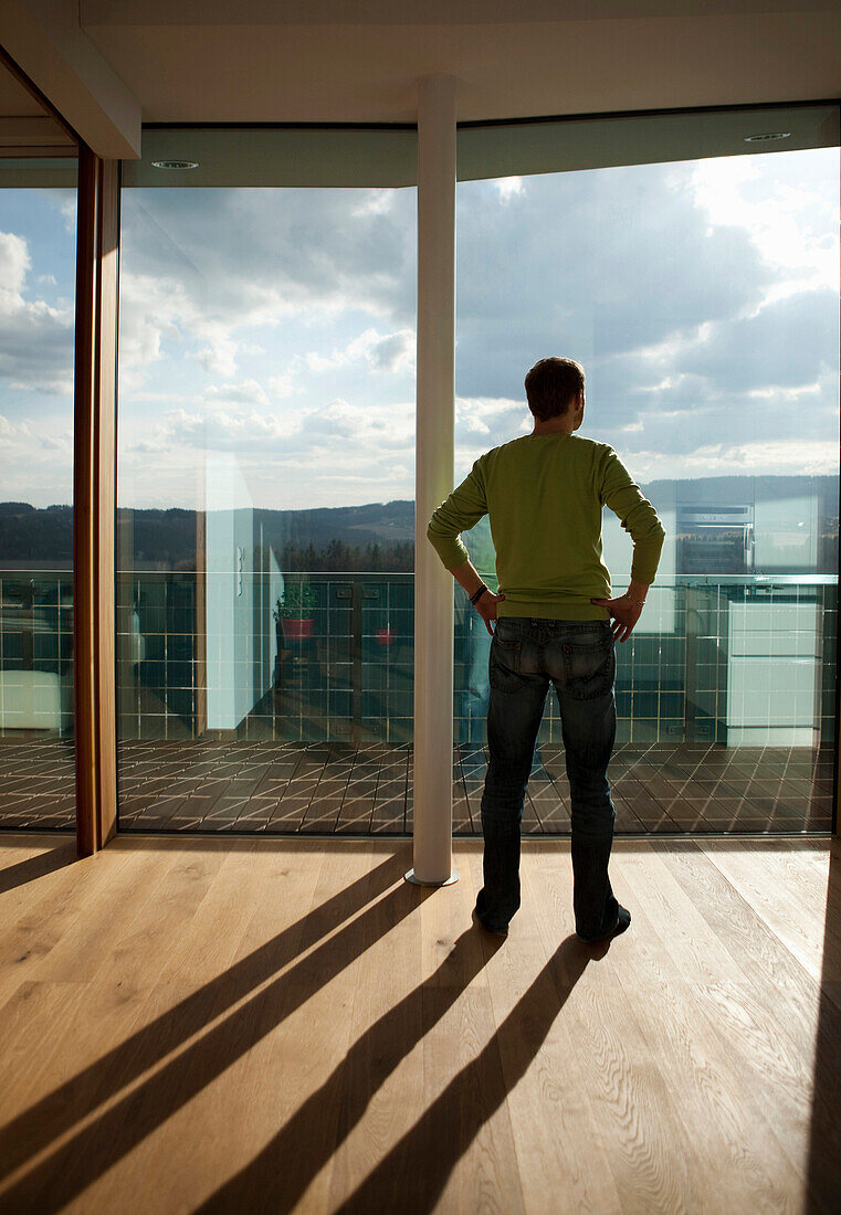 Mid adult man looking out of a window, Styria, Austria