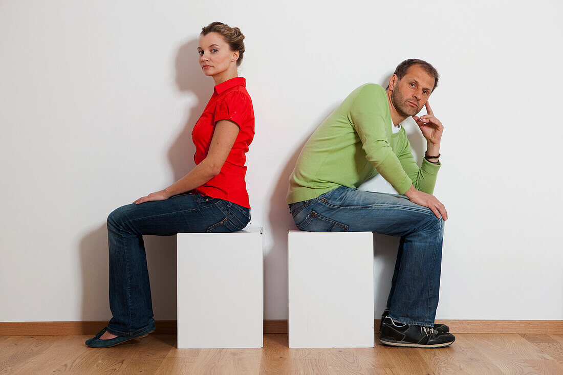 Angry couple sitting back to back, Vienna, Austria