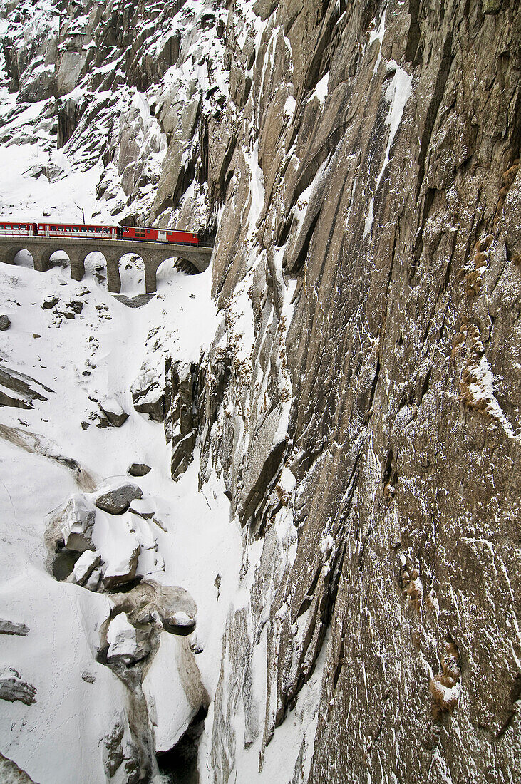 Glacier Express in winter near Andermatt, Canton of Uri, Switzerland