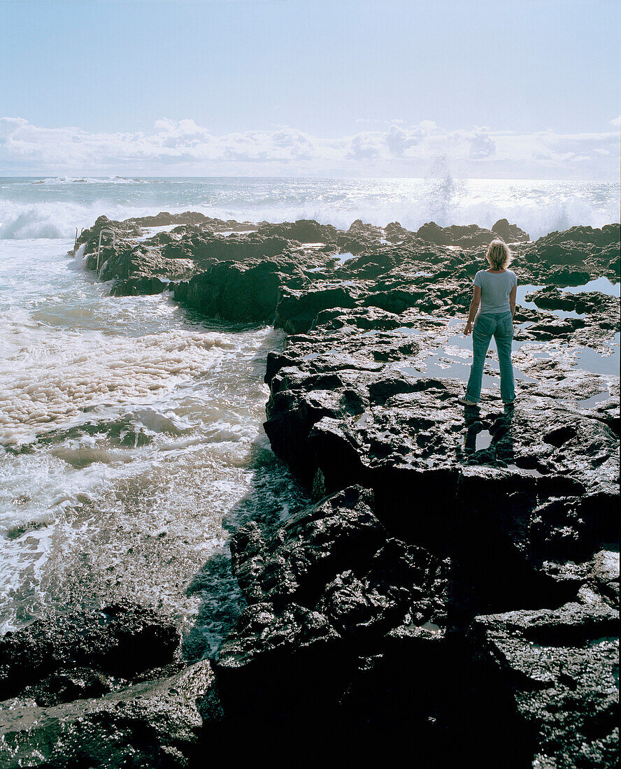 Woman on cliffs near Mosteiros, Sao Miguel Island, Azores, Portugal