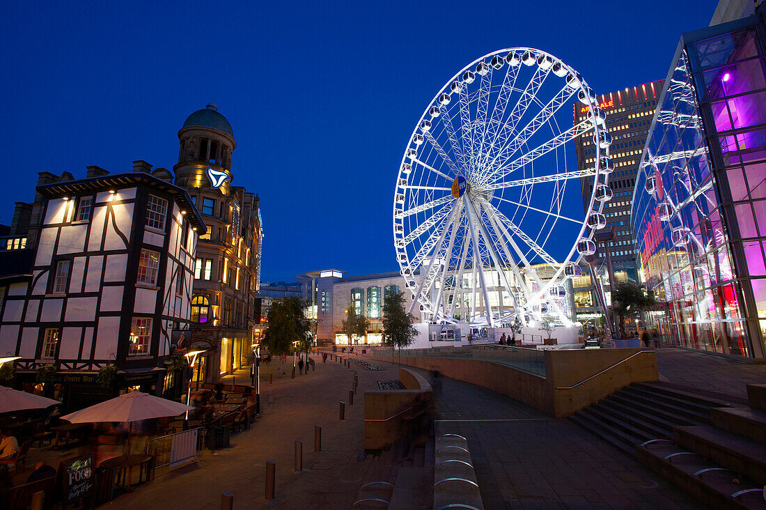 City at night - ferris wheel and street scene, Manchester, Greater Manchester, UK - England