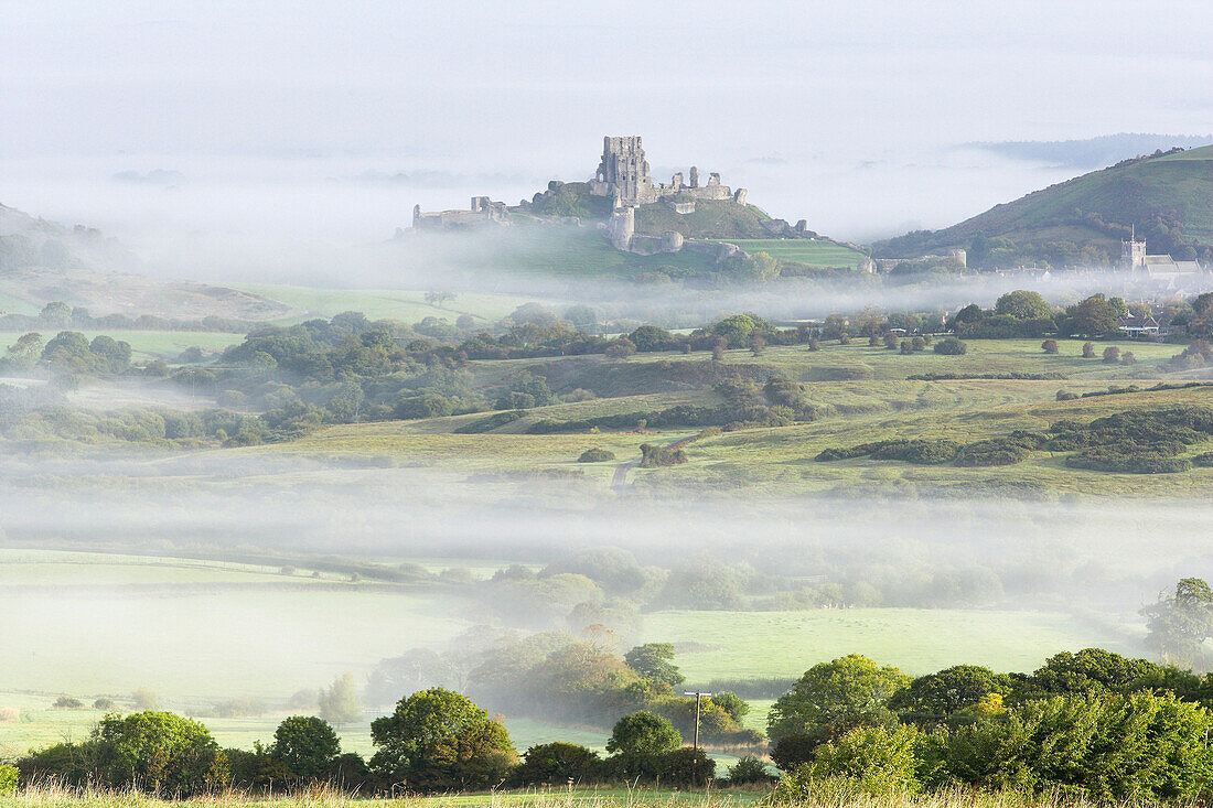 Corfe Castle viewed from Kingstone rising out of the mist Purbeck Dorset, Corfe, Dorset, UK - England