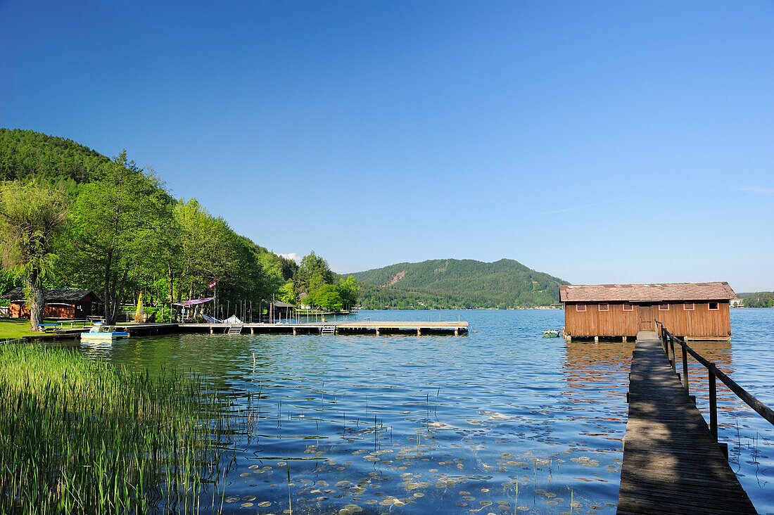 Wooden landing stage and boathouse at lake Klopeiner See, lake Klopeiner See, Carinthia, Austria, Europe