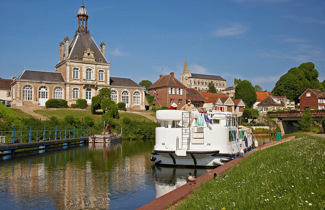 The village Long on the river Somme with townhall, church and houseboat, Dept. Somme, Picardie, France, Europe