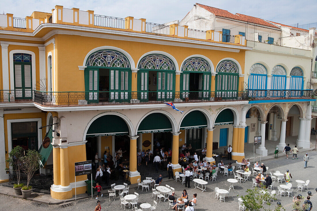 People sitting outside and live music at Taberna de la Muralla Brewery Bar and Restaurant on Plaza Vieja, City of Havana, Havana, Cuba
