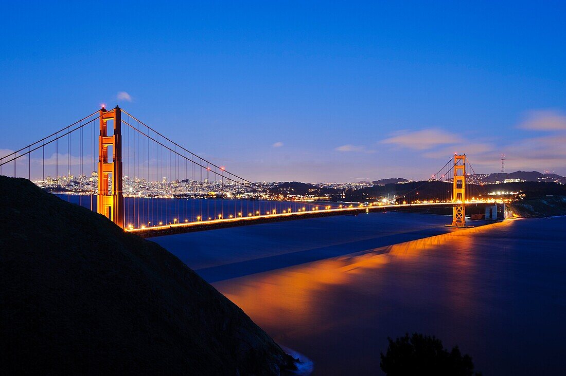San Francisco, CA - The Golden Gate Bridge glows in the late evening light