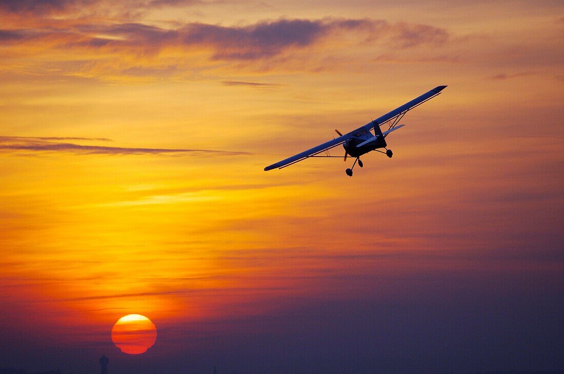 Ultra light aircraft Eurofox turning on a sunset sky Sarreguemines, Moselle, Lorraine, France