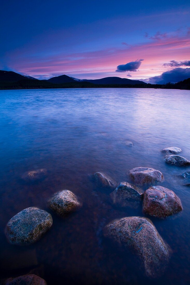 Scotland, Scottish Highlands, Cairngorms National Park Deep red clouds above Loch Morlich and the surrounding mountains