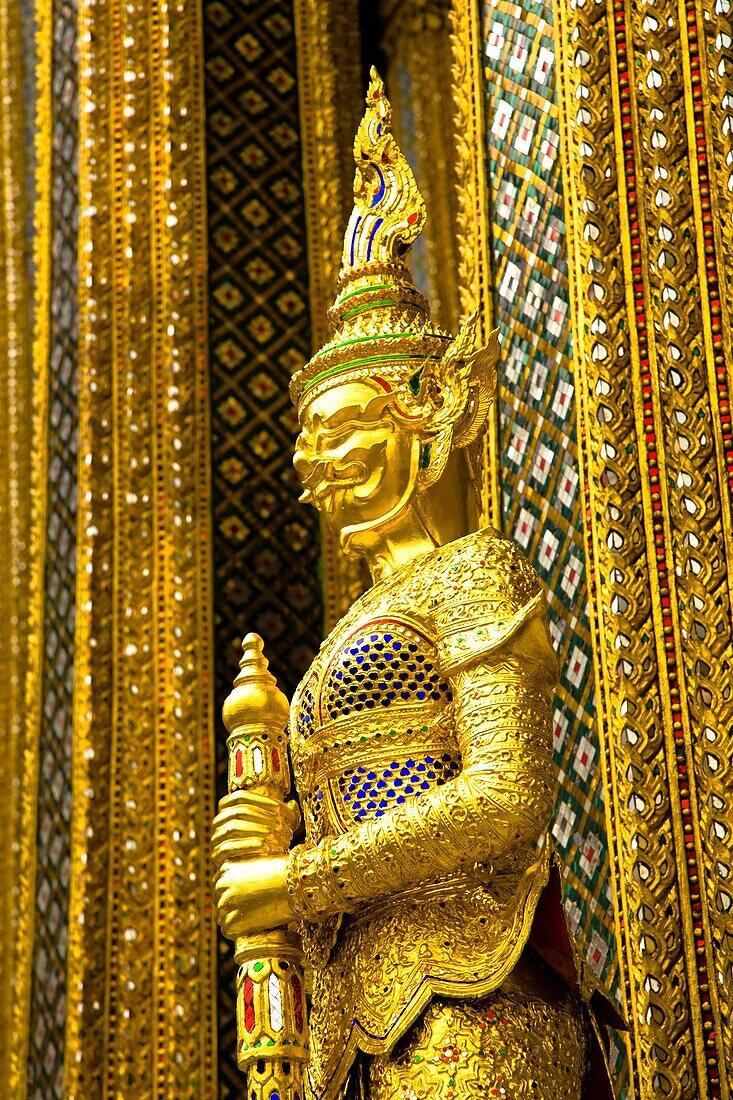 Thailand, Bangkok, The Grand Palace Statue in the ornate setting of the golden grand palace
