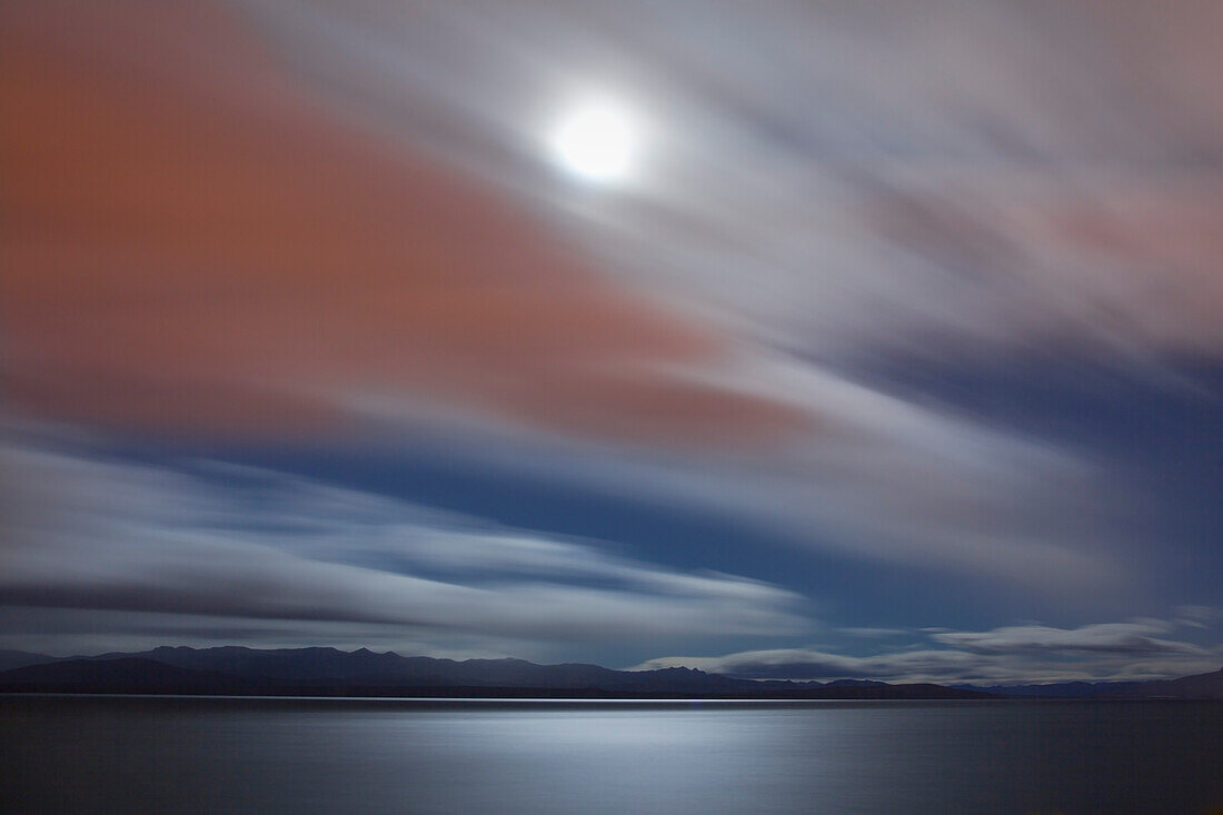 Moonlight breaking through the clouds, view over Lago Nahuel Huapi, near San Carlos de Bariloche, Rio Negro, Patagonia, Argentina