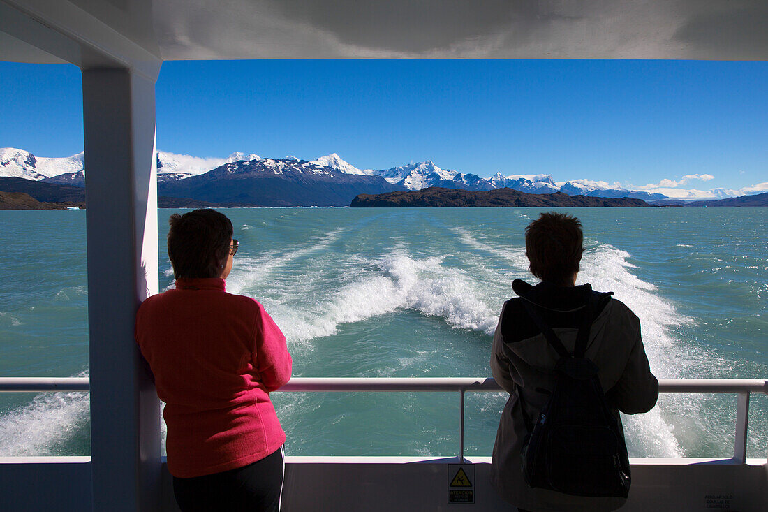 Two women on board a ship on the passage to the glaciers at Lago Argentino, Los Glaciares National Park, near El Calafate, Patagonia, Argentina