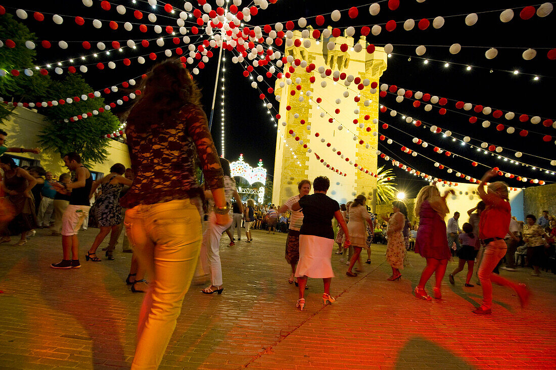 Feria, Menschen mit Bewegungsunschärfe tanzen am Abend, Conil de la Frontera, Andalusien, Spanien, Europa
