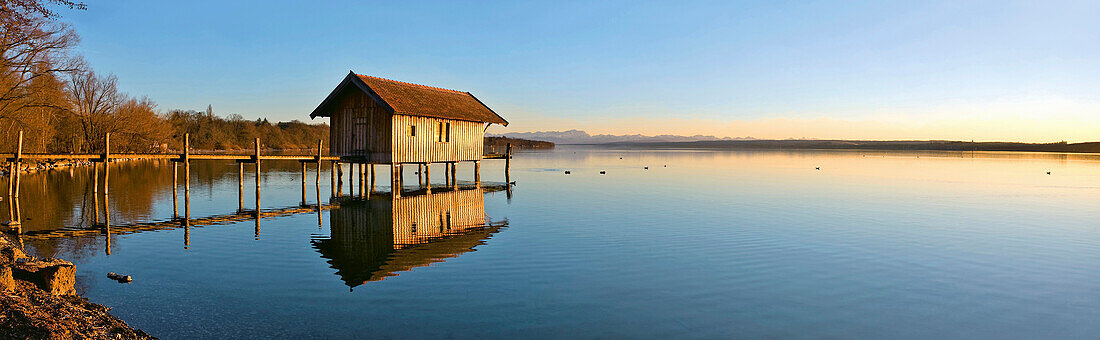 Boathouse and jetty at lake Ammersee at sunset, Upper Bavaria, Germany, Europe