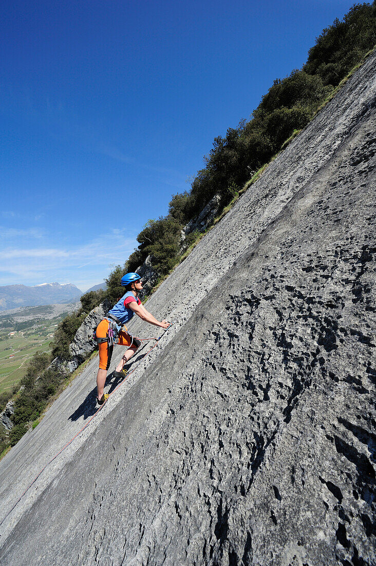 Woman climbing on rock face, Dro, Trentino-Alto Adige/Suedtirol, Italy