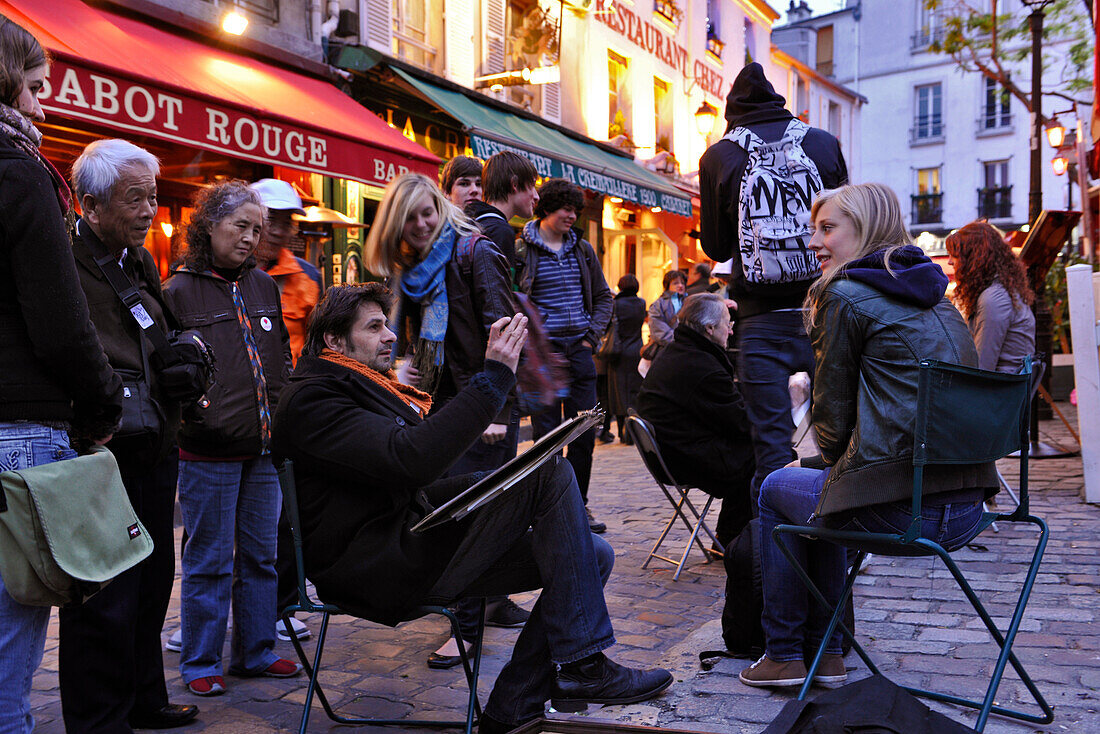 Street artist with tourists in the evening, Montmartre, Paris, France, Europe