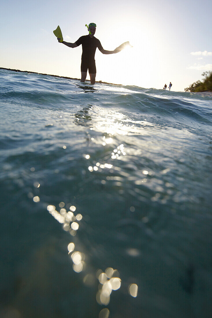 Snorkeler late afternoon near Heron Island, eastern part is part of the Capricornia Cays National Park, Great Barrier Reef Marine Park, UNESCO World Heritage Site, Queensland, Australia