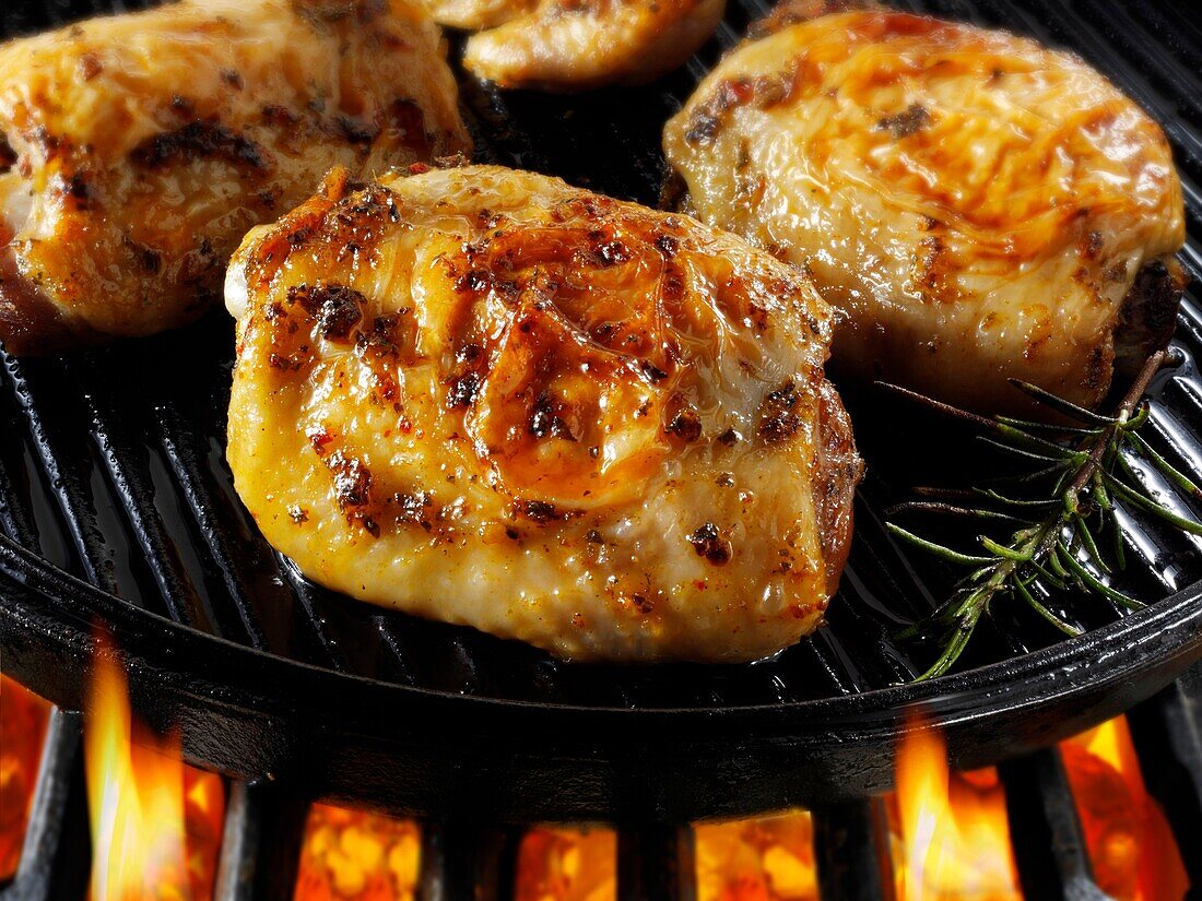 Chicken thighs cooking on a bbq Food