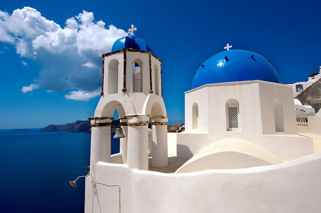 Oia, Ia Santorini - Blue domed Byzantine Orthodax churches, - Greek Cyclades islands.