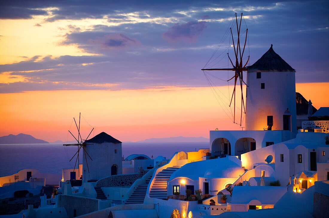 Oia Ia Santorini - Windmills and town at sunset, Greek Cyclades islands .