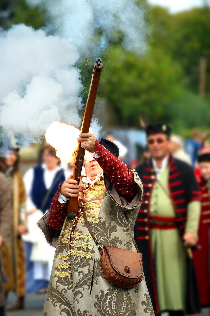 Man firing a musket in tradtional Hungarian costume celebrating the wine festival - Badascony, Hungary