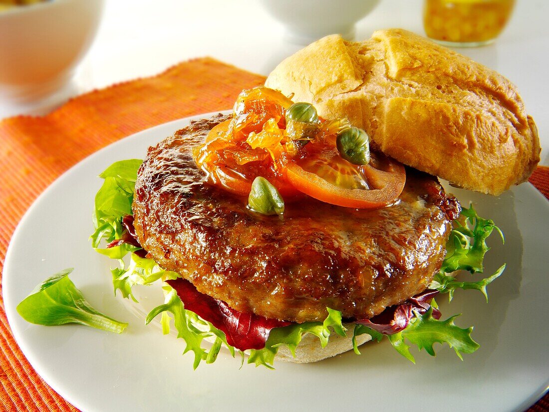 Organic beef burger with tomato relish and salad in a bun